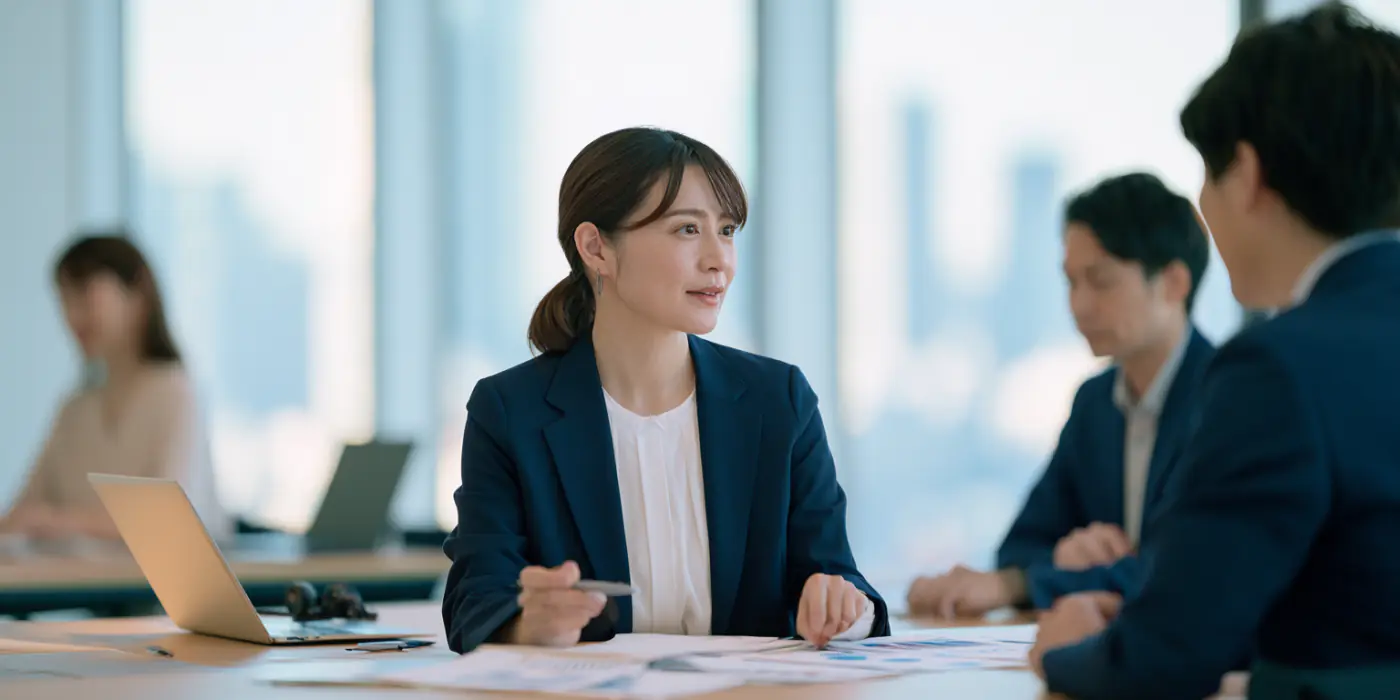 Japanese insurance operations team reviewing a policy renewal workflow